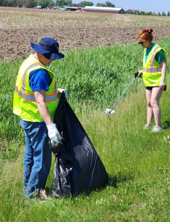 Woody and Baylee participating in road clean-up.